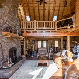 The Great Room with Large Fireplace and a View of the Loft