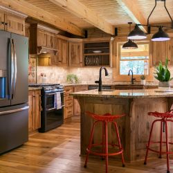 Log Home Kitchen with Custom Cabinetry and Graphite Appliances