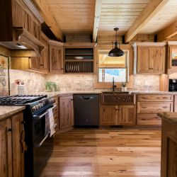 Log Home Kitchen with Imprinted Copper Farmhouse Sink