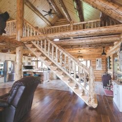 Rustic Half-Log Stairway in Center of Great Room