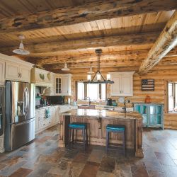 Log Home Custom Kitchen with White Painted Cabinets and Stained Island