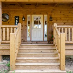 Cedar Log Railing and Spindles on Front Porch of Log Home 