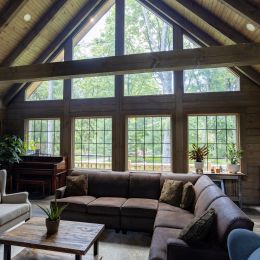 Log Home Great Room with Floor to Ceiling Windows
