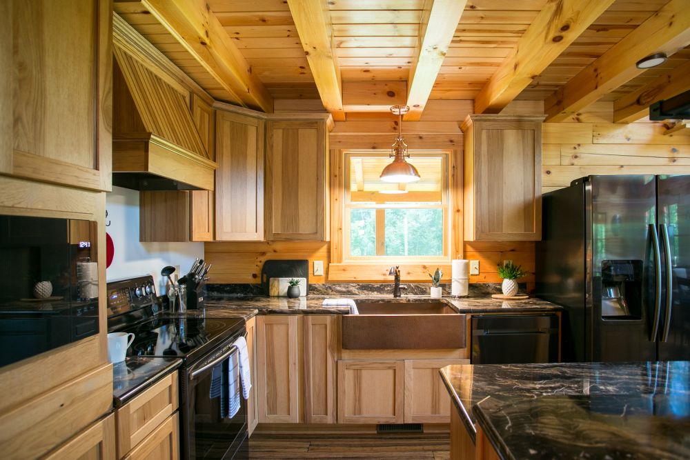 Log Home Kitchen with Copper Farmhouse Sink