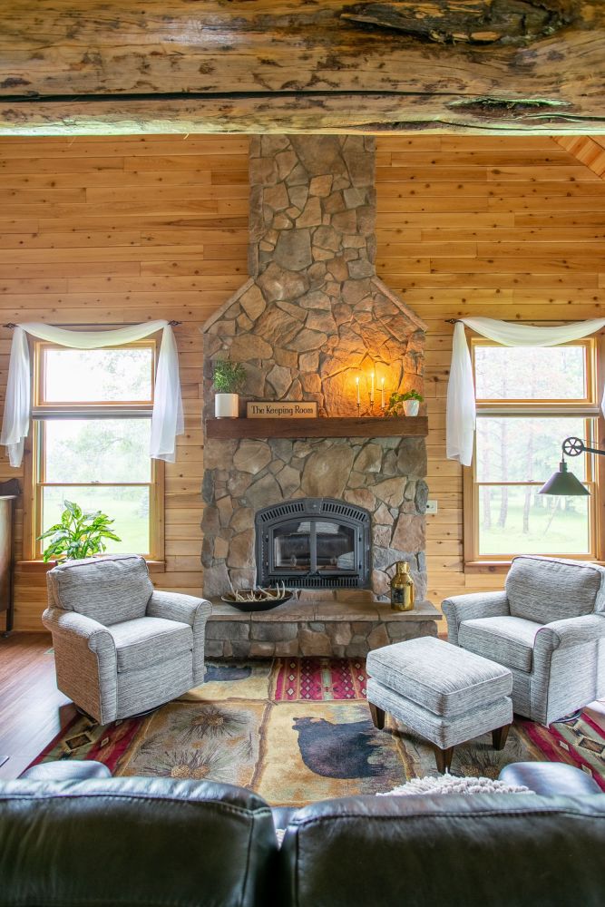 Floor to Ceiling Stone Covered Fireplace with Raised Hearth
