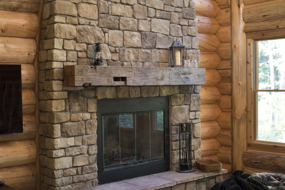 Stone Covered Wood Burning Fireplace with Reclaimed Barn Wood Mantle